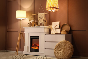 Naklejka premium Interior of cozy room with glowing lamps, dresser and stylish fireplace