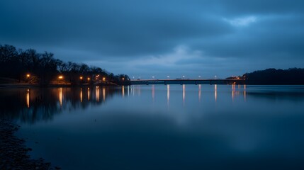 Fototapeta premium Serene Lake at Dusk with Lights Reflecting on Water.