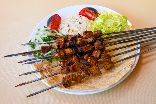 Famous Urfa meat liver, ciger wrapped by lavash with roasted chili pepper, onion and sauce in Sanliurfa, Turkey. Izgara kuzu et sis ciger. Izgara dana bonfile, cop sis, kuzu pirzola. Karisik kebap.