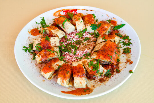 Famous Urfa meat liver, ciger wrapped by lavash with roasted chili pepper, onion and sauce in Sanliurfa, Turkey. Izgara kuzu et sis ciger. Izgara dana bonfile, cop sis, kuzu pirzola. Karisik kebap.