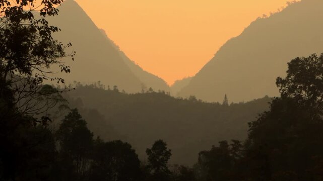 4K wide landscape shot of silhouette mountains during sunset in H&agrave; Giang , Vietnam 