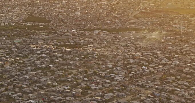 Cape Town South Africa Aerial v104 zoomed birds eye view flyover Khayelitsha township capturing vast informal settlements and view of False Bay at sunset - Shot with Mavic 3 Pro Cine - Jan 11th 2024