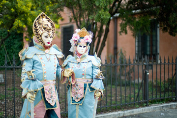 Obraz premium Venice, Italy - February 9, 2026 - People dressed in masks for the Venice Carnival have their photos taken by tourists.