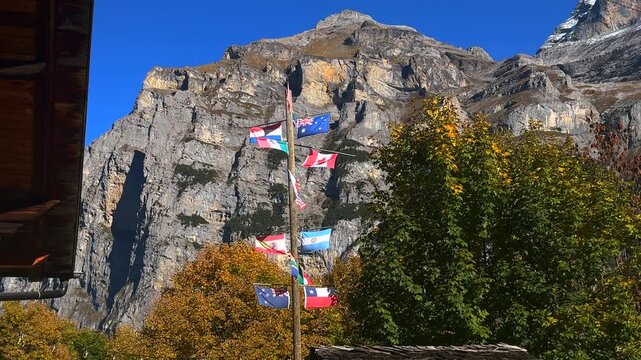 Allmendhubel Mountain World flags Swiss Alps Murren M&uuml;rren Gimmelwald Lauterbrunnen Valley Switzerland Schweiz Autumn Fall alpine village Chalet lodge sunny blue sky Jungfrau region Schilthorn Piz Glo