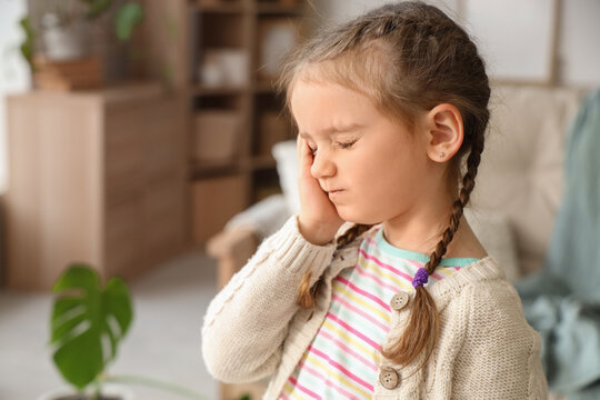 Little girl feeling tooth ache at home