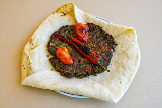 Famous Urfa meat liver, ciger wrapped by lavash with roasted chili pepper, onion and sauce in Sanliurfa, Turkey. Izgara kuzu et sis ciger. Izgara dana bonfile, cop sis, kuzu pirzola. Karisik kebap.