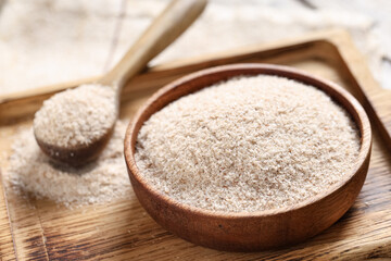 Bowl with psyllium husk powder on board, closeup © Pixel-Shot