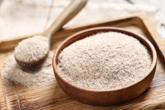Bowl with psyllium husk powder on board, closeup