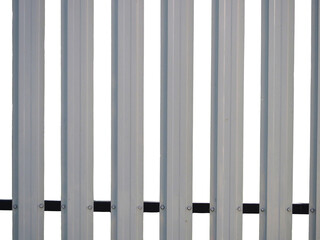 Vertical metal fence panel background texture, silver gray industrial security barrier