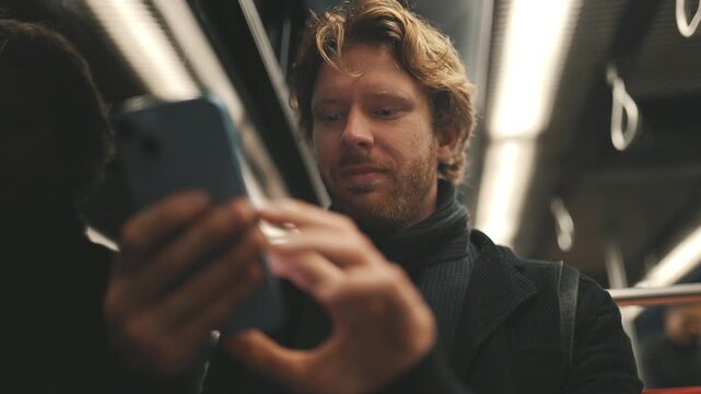 Commuter using smartphone on crowded public transport