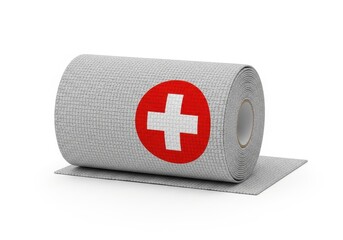 Fototapeta premium Roll of cohesive medical bandage featuring a prominent red and white cross symbol is isolated on white