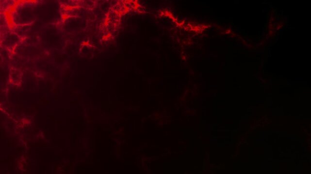 Dark red fire embers and glowing ashes with dynamic particle motion. Abstract hot energy texture creating intense cinematic atmosphere on black background.