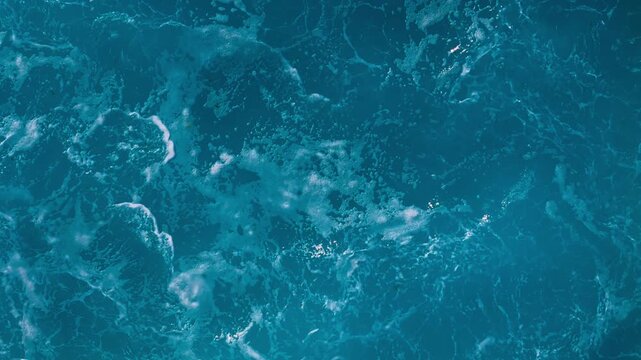 Dynamic ocean water texture with strong wave motion and white sea foam