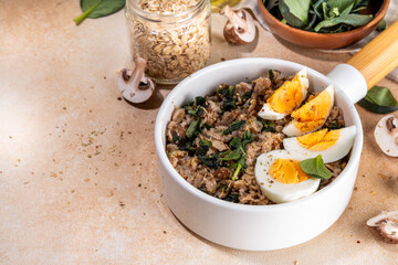 Tasty savory overnight oatmeal with spinach, mushrooms and eggs