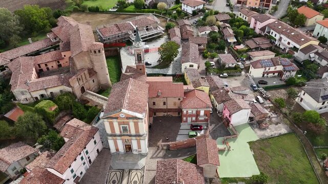 Calendasco in the Piacenza province, featuring the medieval Castello di Calendasco, Church of Santa Maria Assunta, birthplace of San Corrado Confalonieri Saint, in expansive rural Po Valley, pull out