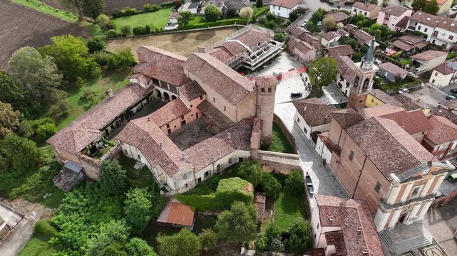 Calendasco village in the Piacenza province, featuring medieval Castello di Calendasco, the Church of Santa Maria Assunta, and the expansive rural Po Valley