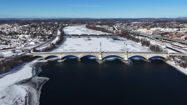 Aerial tracking left across Memorial Bridge in Springfield Massachusetts in winter