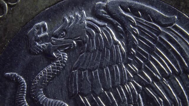 Detailed close-up of a coin with eagle and snake motif, concept of currency