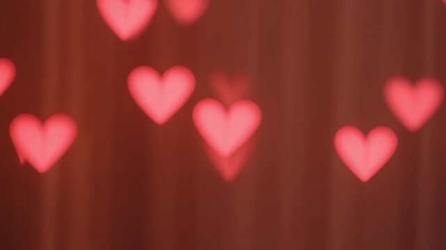 Abstract Valentine background featuring blurred heart bokeh particles drifting softly romantic atmosphere cinematic depth gentle motion dreamy lighting seamless loop elegant color harmony festive love
