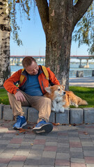 man and dog corgi