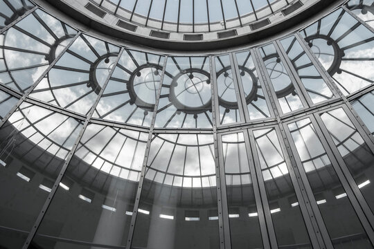 Interior glass dome ceiling skylight with circular pattern and symmetry structure creating bright architecture background for museum hall design concept