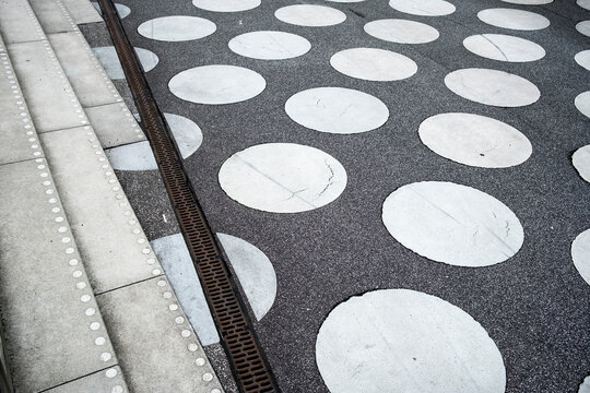 Urban concrete walkway pavement with circles pattern and abstract geometry creating texture surface for modern public space background and design use