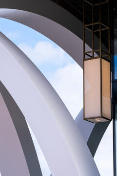 Modern architecture arch with metal lantern detail and blue sky showing abstract curve and design lines for elegant exterior background