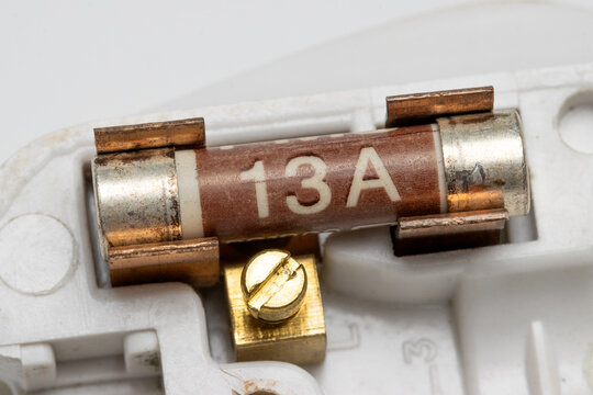 13 ampere ceramic fuse on its holder isolated on white background.