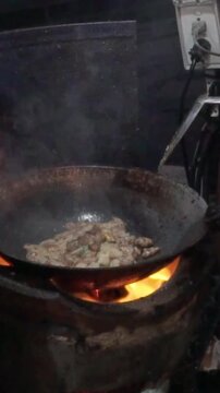 thai food pork meal. street food with iron pot on  traditional cley vase with ember