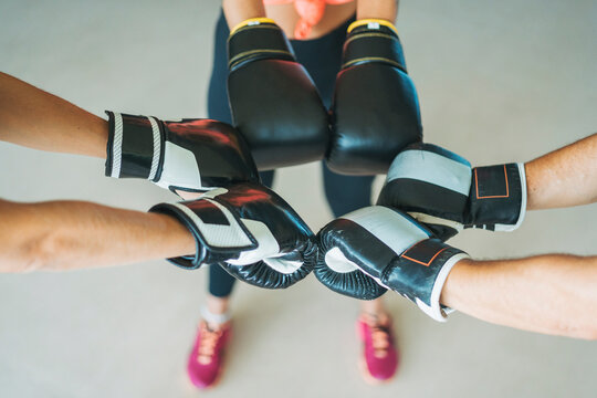 Close-up of training partners with boxing gloves in gym