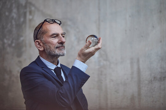 Senior businessman looking at crystal ball