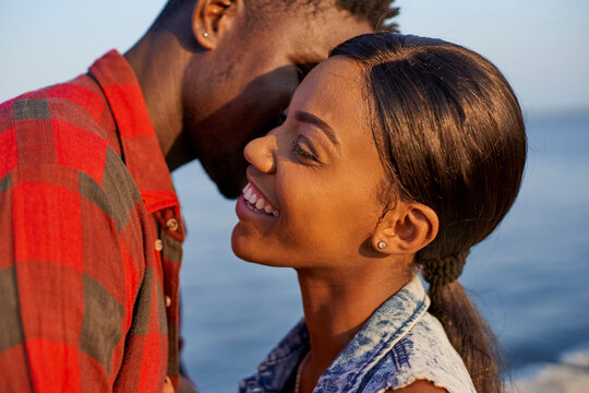 Romantic couple standing at the sea, portrait