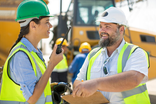 Male and female quarry workers discussing on site