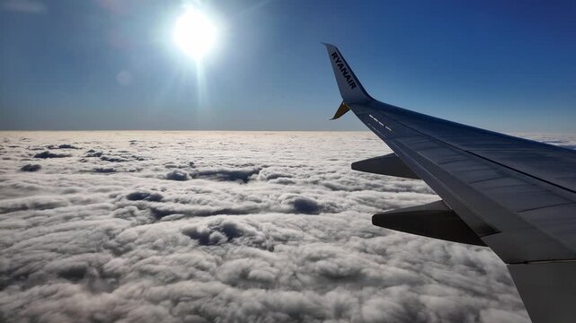 Ryanair airplane wing mid flight over the Atlantic ocean