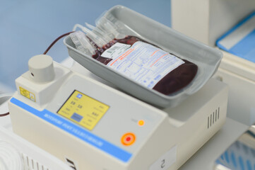 Blood bag on weighing scale during plasma donation process