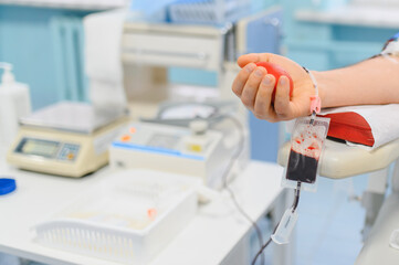 Person donating blood in medical facility, saving lives
