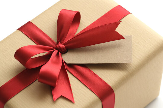 Close-up of Kraft Paper Gift Box with Red Satin Ribbon and Blank Tag - Gift Giving Concept