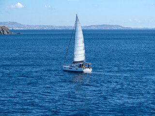 Fototapeta premium Beautiful yacht off the coast of Mykonos in the Aegean Sea in Greece