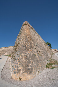 View of the imposing stone fortress walls rise against a clear blue sky, showcasing the robust architecture and historical significance, Sibenik, Croatia.