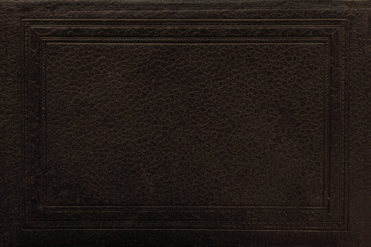 Vintage book cover. Dark leather texture with embossed rectangular frame and subtle grain detail. Natural mockup, background with copy space