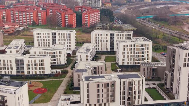 Modern Urban Living: An aerial view showcases a cluster of contemporary buildings, forming a vibrant residential community. Capturing the essence of modern urban architecture and residential living.