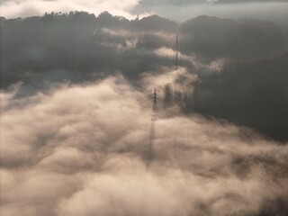 Fototapeta premium The sky is covered in fog and the sun is barely visible. The clouds are low and the sky is gray