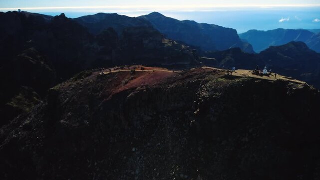 4K Drone Orbit of Pico Ruivo Summit, Madeira: View of Pico do Areeiro Observatory on Horizon, Hikers on PR1.2 Trail, Dramatic Volcanic Ridges and Clouds, Cinematic Establishing Mountain Shot