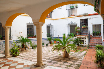 Fototapeta premium Typical Andalusian Patio with Traditional Arches and Potted Plants, Cordoba, Spain