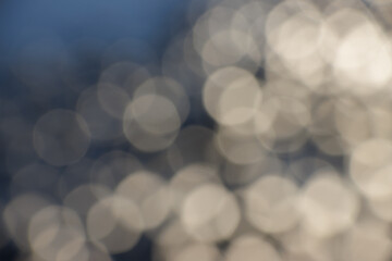Abstract white bokeh on dark blue background