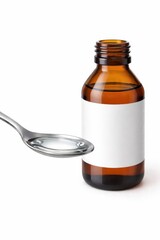 Metal spoon holding clear liquid medicine dose with amber bottle blank label clean home healthcare concept high key studio isolated on white