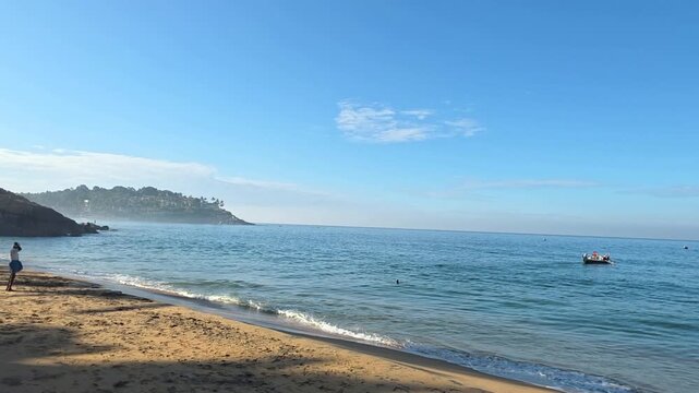 Calm beach scene with fishing boat in Mannar, Kerala