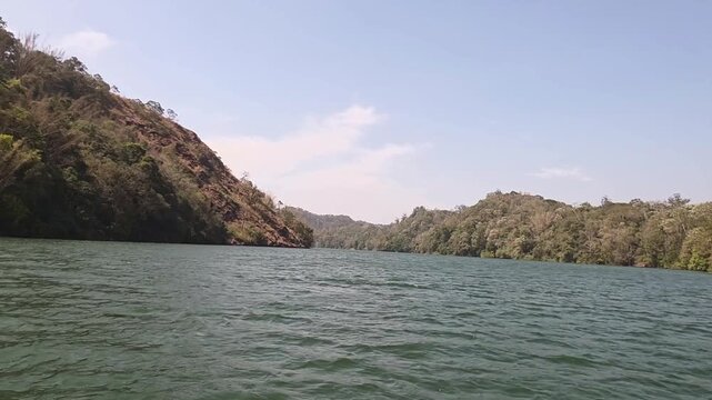Scenic river view surrounded by lush hills in Kerala