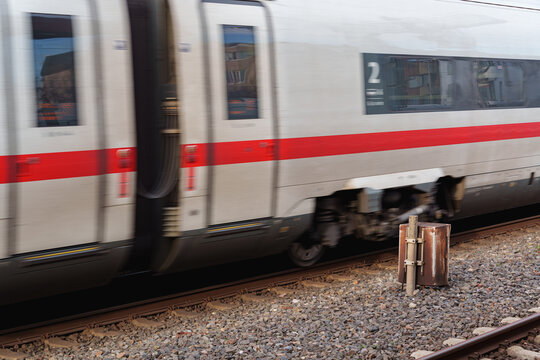 German Deutsche Bahn ICE high speed train moving through D&uuml;sseldorf main station platform in motion