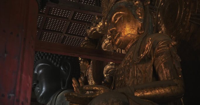 Old, massive, majestic buddhist statues in ancient Osaka castle - low shot